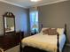 Comfortable bedroom featuring a full bed, dresser, and a window at 126 W Quail Ridge Rd, Oxford, NC 27565