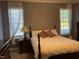 Cozy bedroom features bright windows, curtains, neutral colors and a ceiling fan at 126 W Quail Ridge Rd, Oxford, NC 27565
