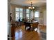 Well-lit dining room with wood floors, bright windows, and a classic chandelier at 126 W Quail Ridge Rd, Oxford, NC 27565