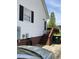 Rear exterior of the home featuring an elevated deck with steps and a white siding at 126 W Quail Ridge Rd, Oxford, NC 27565