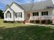Charming front exterior view with a landscaped yard, porch, and classic architectural details at 126 W Quail Ridge Rd, Oxford, NC 27565