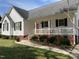 Attractive home showcasing a manicured lawn, brick foundation, and welcoming front porch at 126 W Quail Ridge Rd, Oxford, NC 27565