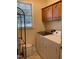 Bright laundry room featuring modern washer and dryer and wood cabinetry at 126 W Quail Ridge Rd, Oxford, NC 27565