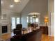 Open living room and dining area with natural light, hardwood floors, and a view of the fireplace at 126 W Quail Ridge Rd, Oxford, NC 27565