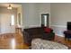 Cozy living room with hardwood floors, neutral paint, and a classic sofa and decor at 126 W Quail Ridge Rd, Oxford, NC 27565
