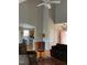 Bright living room with vaulted ceiling featuring hardwood floors, neutral walls, and a ceiling fan at 126 W Quail Ridge Rd, Oxford, NC 27565