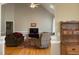 Bright living room boasts vaulted ceiling, ceiling fan and comfortable furnishings at 126 W Quail Ridge Rd, Oxford, NC 27565