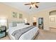 Comfortable primary bedroom features a ceiling fan, bedside tables and an ensuite bathroom at 1524 Catch Fly Ln, Durham, NC 27713