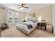 Cozy bedroom with neutral walls, a ceiling fan, and an abundance of natural light at 1524 Catch Fly Ln, Durham, NC 27713