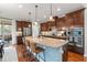 Modern kitchen with a large center island, barstool seating, and stainless steel appliances at 1524 Catch Fly Ln, Durham, NC 27713