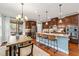 Gourmet kitchen featuring a large center island, stainless steel appliances, and stylish pendant lighting at 1524 Catch Fly Ln, Durham, NC 27713