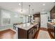 Bright eat-in kitchen featuring a center island, dining area and stainless steel refrigerator at 1524 Catch Fly Ln, Durham, NC 27713
