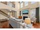Inviting living room with a cozy fireplace, large windows, and an open view to the upper level at 1524 Catch Fly Ln, Durham, NC 27713