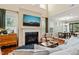 Spacious living room with a fireplace, large windows, and seamless access to the dining area at 1524 Catch Fly Ln, Durham, NC 27713