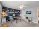 Bright office featuring large built-in desk with shelves and modern ceiling fan at 1524 Catch Fly Ln, Durham, NC 27713