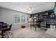 Bright, spacious home office featuring built-in desks, shelves, and large windows at 1524 Catch Fly Ln, Durham, NC 27713