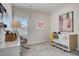 Bright Bedroom with a white crib, rocking chair, and colorful artwork, creating a calming space at 160 Bruce Dr, Dunn, NC 28334