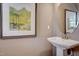 Elegant powder room with a pedestal sink and decorative artwork at 160 Bruce Dr, Dunn, NC 28334