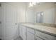 Bathroom featuring granite countertops, white cabinetry and a framed mirror above the sink at 185 W Amber Oak Dr, Selma, NC 27576