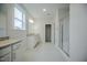 Modern bathroom featuring granite countertops, dual vanity sinks, and a glass-enclosed shower at 185 W Amber Oak Dr, Selma, NC 27576