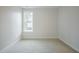 Spare bedroom featuring a window with exterior views and carpet floors at 185 W Amber Oak Dr, Selma, NC 27576