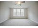 Bright bedroom offers plush carpet and great natural light with a ceiling fan and ample space at 185 W Amber Oak Dr, Selma, NC 27576