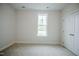 Neutral bedroom featuring a window offering natural light and a closet providing storage space at 185 W Amber Oak Dr, Selma, NC 27576