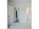 Neutral bedroom with plush carpeting leads to ensuite bathroom and hallway at 185 W Amber Oak Dr, Selma, NC 27576