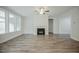 Expansive living room offers a fireplace, large windows, and a versatile layout for relaxation and entertainment at 185 W Amber Oak Dr, Selma, NC 27576