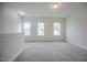 Bright, carpeted loft space illuminated by three windows, offering views of the surrounding neighborhood at 185 W Amber Oak Dr, Selma, NC 27576