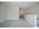 Carpeted loft area featuring a storage closet, offering versatile space for relaxation and entertainment at 185 W Amber Oak Dr, Selma, NC 27576