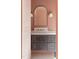 Modern bathroom vanity with dark cabinets, stone countertop, and elegant arched mirror at 186 Evington Dr, Pittsboro, NC 27312