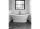 Elegant bathroom with a freestanding tub, herringbone tile floors, and a large window for ample natural light at 186 Evington Dr, Pittsboro, NC 27312