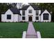 Stunning two-story home with a manicured lawn and a beautiful walkway leading to the front door at 186 Evington Dr, Pittsboro, NC 27312