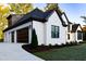Elegant home exterior with dark trim, a two-car garage, and a well-maintained lawn at 186 Evington Dr, Pittsboro, NC 27312