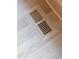 Stylish floor vent seamlessly integrated into the light hardwood flooring, showcasing attention to detail and design at 186 Evington Dr, Pittsboro, NC 27312