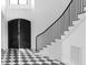 Bright foyer featuring a curved staircase and a striking black and white checkerboard floor at 186 Evington Dr, Pittsboro, NC 27312