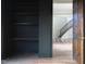 Inviting foyer with hardwood floors and staircase, showcasing a seamless blend of dark wood shelves and a light-filled area at 186 Evington Dr, Pittsboro, NC 27312