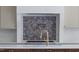 Detailed view of kitchen backsplash with colorful tiles and a modern faucet at 186 Evington Dr, Pittsboro, NC 27312