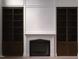 Elegant living room featuring a fireplace with built-in bookcases and decorative moldings at 186 Evington Dr, Pittsboro, NC 27312