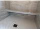 Modern walk-in shower featuring gray subway tile, a built-in bench, decorative tile floors and a sleek drain at 186 Evington Dr, Pittsboro, NC 27312