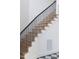 Elegant staircase with light wood steps and a sleek black railing at 186 Evington Dr, Pittsboro, NC 27312