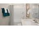 Bathroom showcasing a sink with teal towels, a shower-tub combination, and neutral decor at 201 Olive Branch St, Sanford, NC 27332