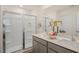 Modern bathroom featuring a glass-enclosed shower, double sinks with gray cabinets, and quartz countertops at 201 Olive Branch St, Sanford, NC 27332