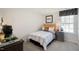 Bedroom featuring a window, a bed with a patterned duvet, and a side table with drawers at 201 Olive Branch St, Sanford, NC 27332