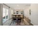 Bright dining area featuring a wooden table, black chairs, and sliding glass doors at 201 Olive Branch St, Sanford, NC 27332