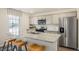Modern kitchen featuring stainless steel appliances, granite countertops, and eat-in island at 201 Olive Branch St, Sanford, NC 27332