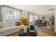 Open-concept living space with a comfortable sofa, dining area, and bright, airy ambiance at 201 Olive Branch St, Sanford, NC 27332