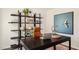 Well-appointed office space with sleek desk, chair, shelving, and plenty of decor at 201 Olive Branch St, Sanford, NC 27332
