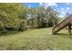 An exterior view of the expansive backyard with grassy lawn and access stairway at 204 Allen St # A/B, Creedmoor, NC 27522